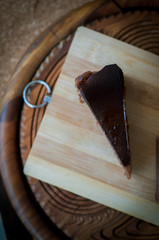 Burnt chocolate cheesecake on brown wooden background. selective focus