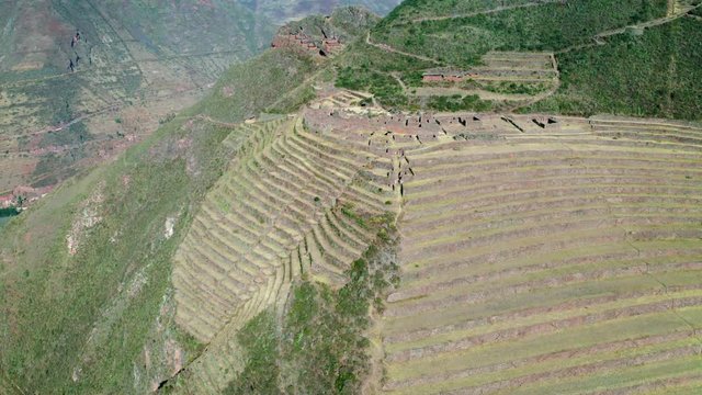 Aerial view of the ancient Inca ruins of Pisac (Pisaq) in the Sacred Valley near Cusco, Peru. Archaeological park with green terraces.