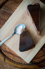Burnt chocolate cheesecake on brown wooden background. selective focus