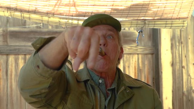 Fidel Castro impersonator, imitating the late Cuban leader's gestures. Funny humorous clip designed to make people laugh. Slow motion.