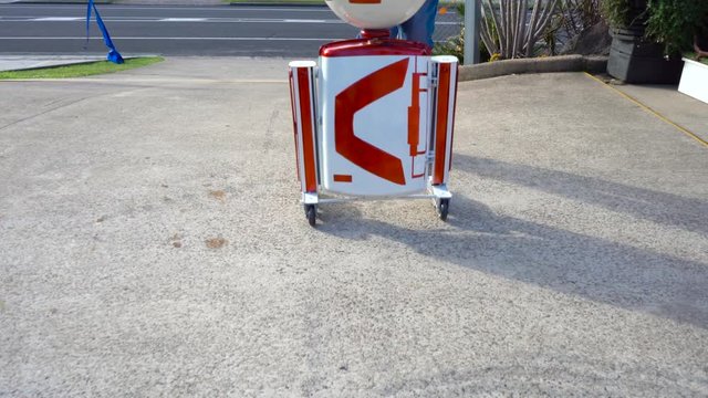 white and red oval head robot moves to right frame and spins head close up. Filmed at Australia, Queensland, Sunshine Coast, Maroochydore in 4K.