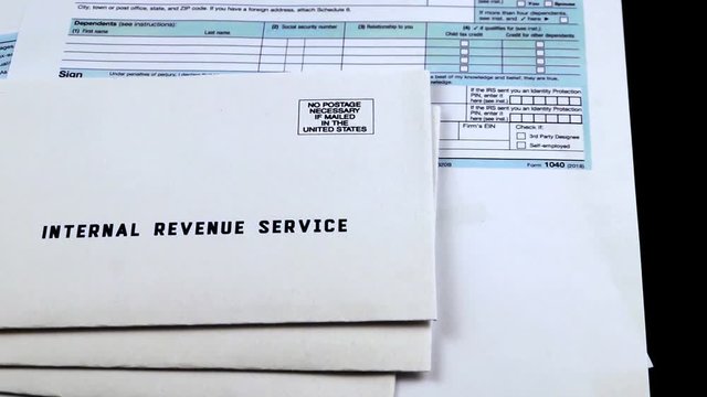 Three mails from the Internal Revenue Service on 1040, Schedule D form 1040 and 1040a tax forms