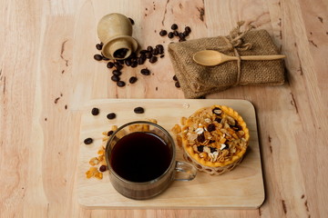 Delicious homemade egg tarts with cup of coffee.Coffee with egg tarts on wood table