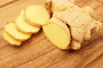 Raw ginger root on wooden background