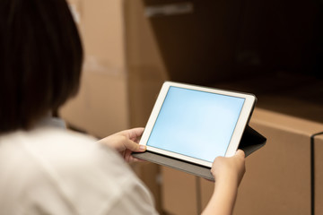 worker hand holding pad for check order pick time in smart factory warehouse