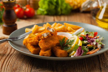 Fish sticks with fries and salad.