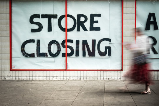 Store Closing sign in shopping high street window