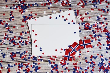 Norwegian independence day, Constitution day, may 17. holiday of freedom, victory and memory, day off. The concept of patriotism and faith. paper confetti and mini flags with white sheets of paper 