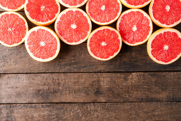 Grapefruit halves on wooden background with copyspace