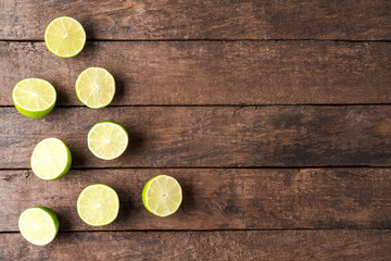 Overhead shot of limes on wooden table