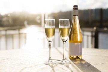 Champagne for romantic celebrations and enjoy for special moments. Two romantic glasses of sparkling champagne alongside a bottle in copy space to celebrate a wedding, anniversary, New year