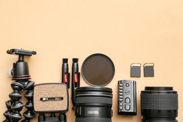 Modern equipment of professional photographer on color background