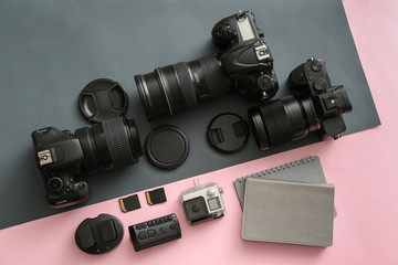 Modern equipment of professional photographer on color background