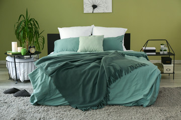 Big comfortable bed in stylish interior of room