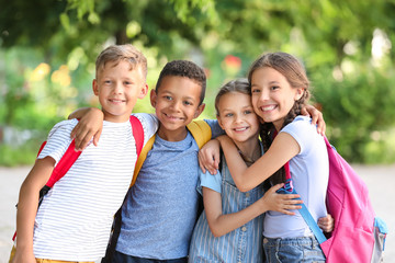 Group of cute little pupils outdoors