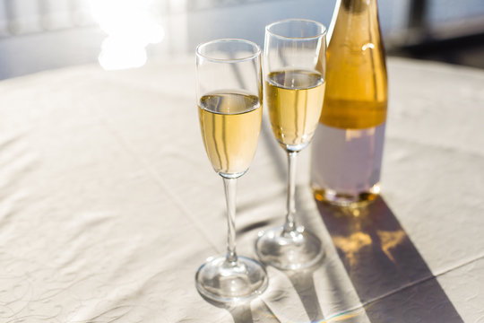 Champagne for romantic celebrations and enjoy for special moments. Two romantic glasses of sparkling champagne alongside a bottle in copy space to celebrate a wedding, anniversary, New year