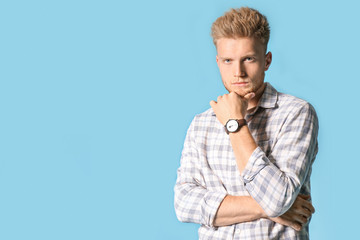 Stylish young man on color background