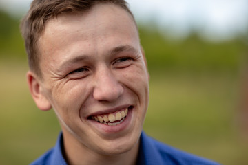 the guy in the blue shirt outdoors on a summer day