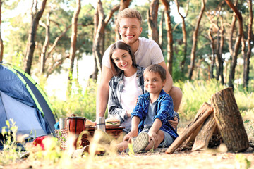 Happy family spending weekend in forest