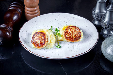 Modern cuisine. Close up view on reastaurant serving cutlet from turkey on mashed potato with micro green on white plate. Healthy food concept. Grilled meat. burger. Flat lay