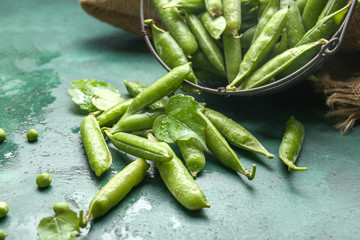 Tasty fresh peas on color background