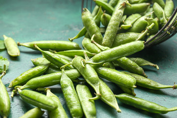 Tasty fresh peas on color background