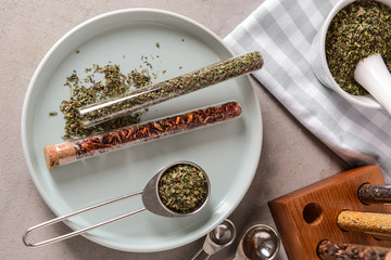 Plate with dry spices on grey table