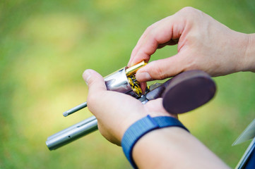 Man loading handgun with ammo in shooting range