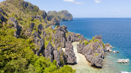 White sand beach near the rocks and boats.Palawan,Busuanga,Tropical beach for tourists aerial view
