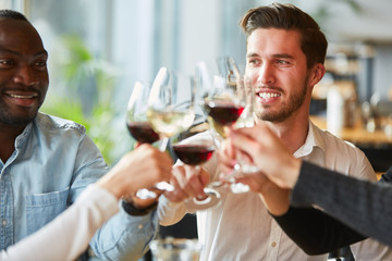 Friends toast with wine in the restaurant