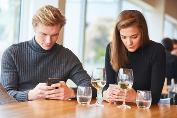 Couple is silent with smartphone in hand