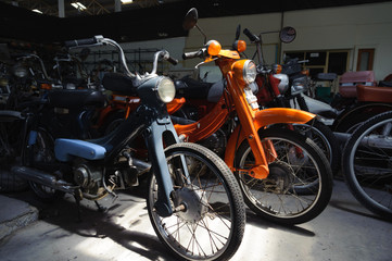 Fototapeta na wymiar Old motocycles park in a warehouse