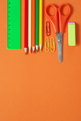 Colorful stationery set on orange
