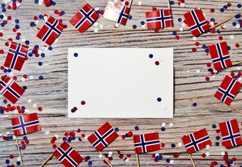 Norwegian independence day, Constitution day, may 17. holiday of freedom, victory and memory, day off. The concept of patriotism and faith. paper confetti and mini flags with white sheets of paper 