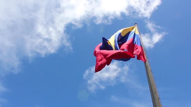 venezuela flag waving in the wind, blue sky cleared.