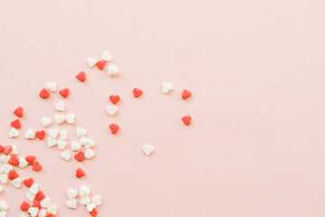 Valentine's Day background with red and white little hearts on pink backdrop. Valentines day concept. Copy space.