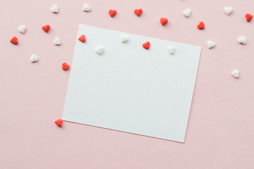 Valentine's Day background with red and white little hearts on pink backdrop. Valentines day concept. Copy space.