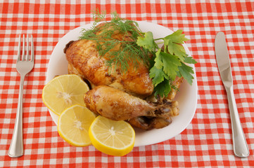 Grilled chicken in white plate on tablecloth