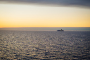 Naklejka na ściany i meble The ferry sails at dawn. Very beautiful sky.