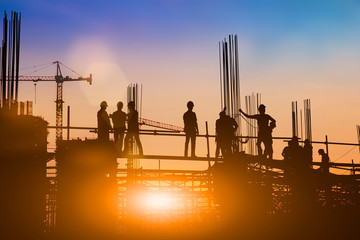 Silhouette of engineer and construction team working at site over blurred background for industry background with Light fair.Create from multiple reference images together - obrazy, fototapety, plakaty