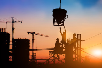 Silhouette of engineer and construction team working at site over blurred background for industry background with Light fair.Create from multiple reference images together