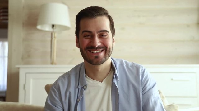 Happy man looking at camera talking video calling, webcam view