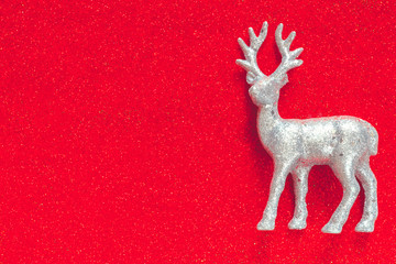 Christmas deer on a red background. New Year's holiday card, flat lay top view