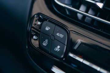 Obraz na płótnie Canvas car interior - the concept of driving Modern car interior details button air conditioner