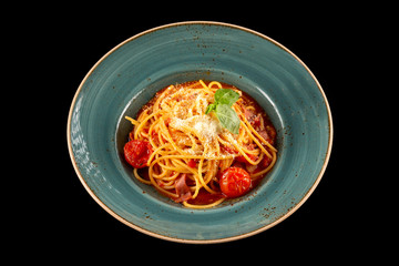 Arabyata pasta with bacon, tomato sauce and parmesan isolated at black background.