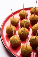 Crispy Veg lollipop recipe made using boiled potato with spices covered with corn flour and bread crumbs coating and then deep fried, served with toothpick or ice cream stock inserted in it with sauce