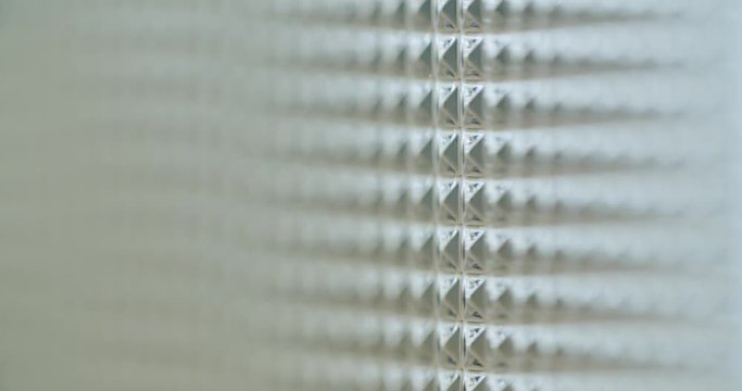 Macro shot of an embossed acrylic grass. The focus changes from the back to the front.