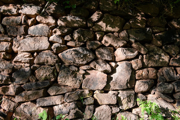Handmade stone wall made of big rock chunks.