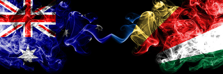 Australia vs Seychelles, Seychelloise smoky mystic flags placed side by side. Thick colored silky smokes combination of national flags of Australia and Seychelles, Seychelloise