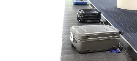 blurred image of luggage bag on roller conveyor in the airport.